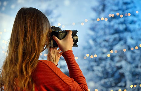 woman taking photo during nighttime thumbnail