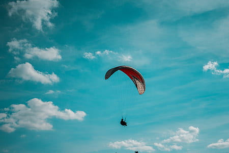person on parachute under blue sky thumbnail