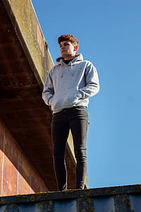 man standing on black cargo container thumbnail