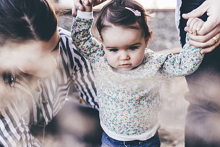 closeup photography of girl in white and multicolored floral long-sleeved shirt thumbnail