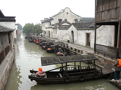 brown wooden boats on body of water in town thumbnail
