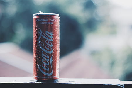 selective focus photography of Coca-Cola can on black surface at daytime thumbnail