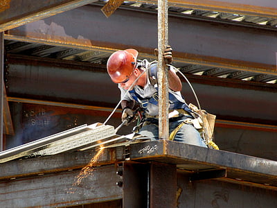 man wearing white shirt and red hard hat holding cutting torch thumbnail