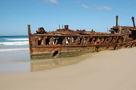 vintage brown metal boat on seashore thumbnail