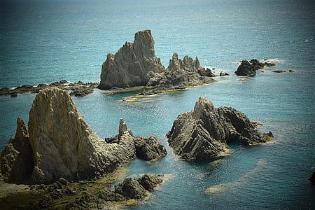 aerial photograph of rock formations on sea thumbnail