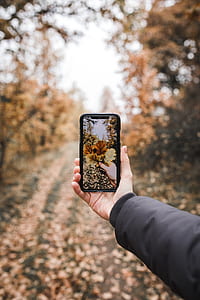 person holding black smartphone thumbnail