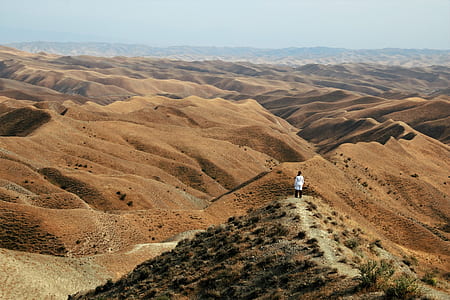person standing on desert during daytime thumbnail