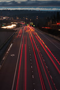 timelapse photography of red lights passing on road thumbnail