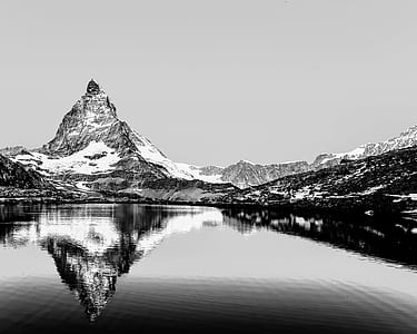 grayscale parabolic photography of mountain thumbnail