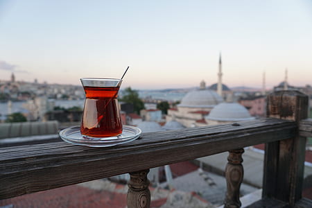 selective focus photography of glass of cocktail on wooden terrace railing thumbnail