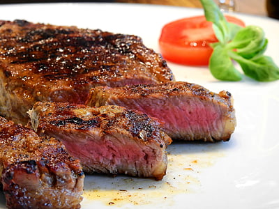 roasted steak with sliced tomato on white plate thumbnail