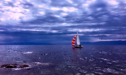 black and white sailing ship on body of water thumbnail