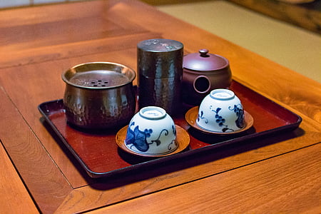 two white-and-blue ceramic bowls and brown ceramic teapot thumbnail