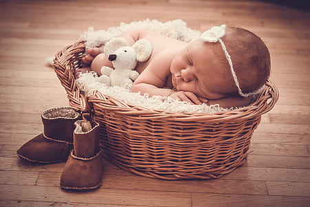 baby laying on wicker basket thumbnail