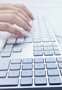 person typing on corded computer keyboard thumbnail