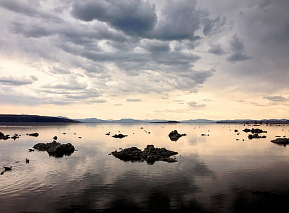 body of water under cloudy sky during daytime thumbnail
