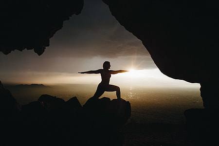 silhouette of woman on peak of mountain during sunset thumbnail