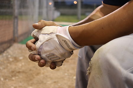 Man in White Gloves Sitting during Nighttime thumbnail
