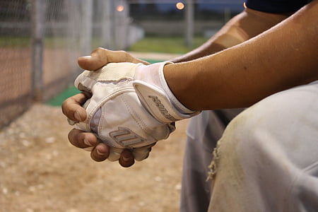 closeup photo of a person wearing white fingerless glove thumbnail