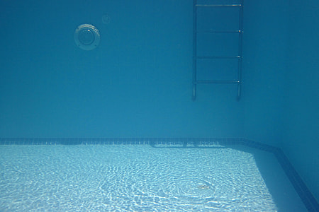 under water shot of swimming pool with metal ladder thumbnail