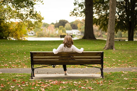 woman sitting on bench at outside park thumbnail