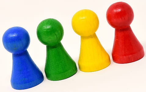 lined up four blue, green, yellow, and red wooden pieces thumbnail