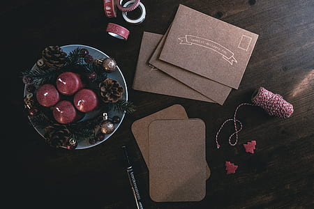 photo of purple pillar candles on plate between pinecones thumbnail