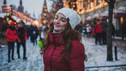 selective focus photography of woman in red bubble jacket thumbnail