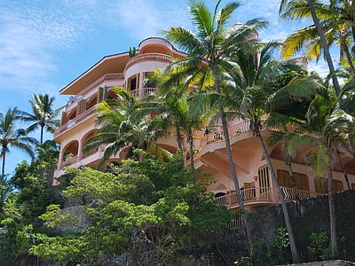 low angle photography of beige house thumbnail