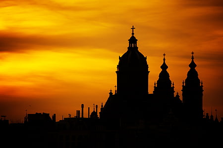 silhoutte of castle under orange sky thumbnail