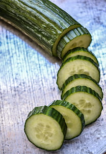 close-up photo of sliced cucumbers on white surface thumbnail