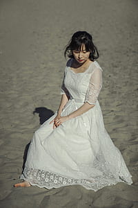 woman sitting on beach sand thumbnail
