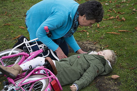 woman carrying child while crashed on bicycle thumbnail
