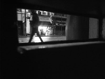 grayscale photograph of man walking thumbnail