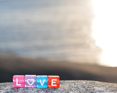 cube with love text on gray concrete surface thumbnail