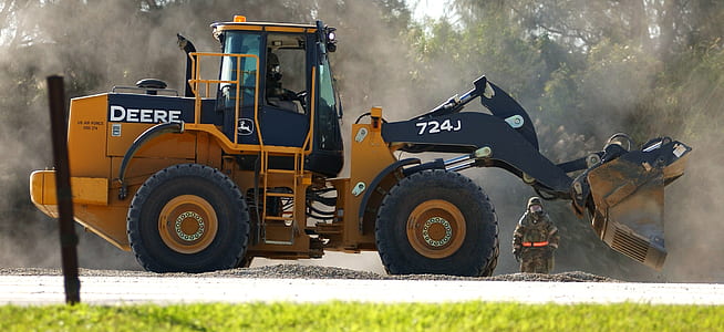 black and orange Deere 724J backhoe loader thumbnail
