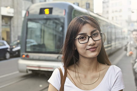 Woman in White Shirt With Eyeglasses Standing Near Train thumbnail