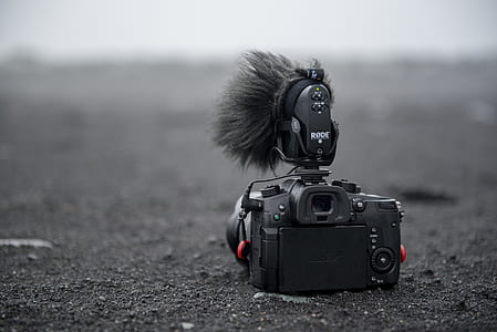 black camera on grey soil thumbnail