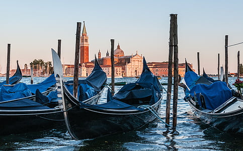 black wooden boat on body of water thumbnail