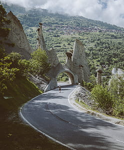 man walking on road toward tunnel thumbnail