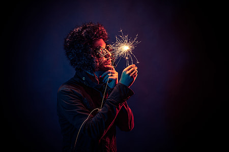 man holds sparkler thumbnail