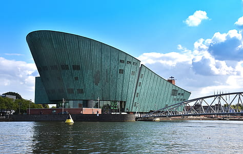 gray building near body of water thumbnail