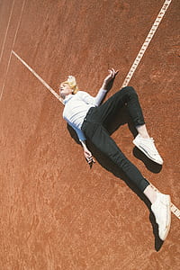 Woman Lying Down on a Brown Concrete Surface thumbnail