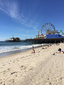 person sitting on sand during daytime thumbnail