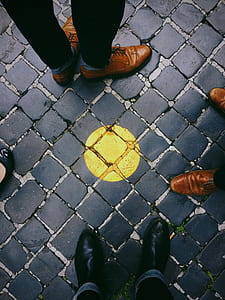 four people standing on blue and yellow clay brick surface thumbnail