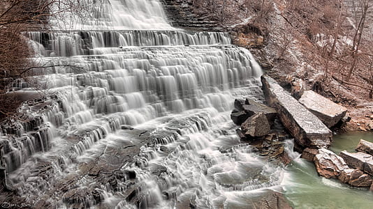 Waterfalls Flowing on Brown Rock Formation Towards River thumbnail