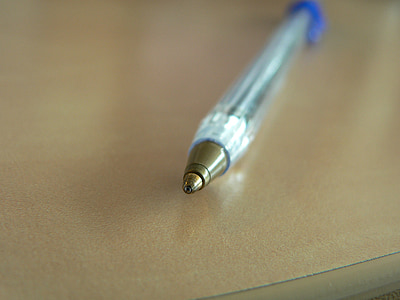 selective focus photography ballpoint pen top on beige surface thumbnail