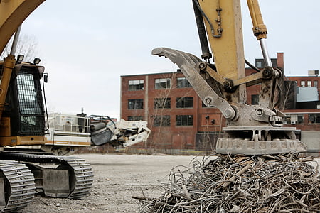 yellow heavy equipment beside building thumbnail