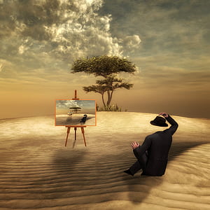 headless man sitting on ground near painting on easel with tall tree background thumbnail
