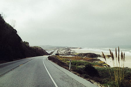landscape photography of road near sea thumbnail